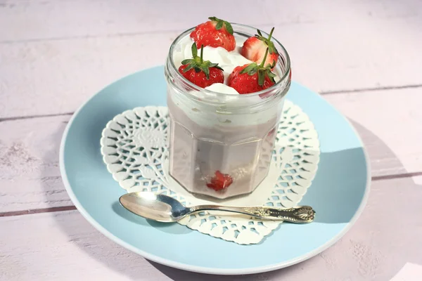 Verse aardbeien met fruit, yoghurt en slagroom op licht roze houten tafel — Stockfoto