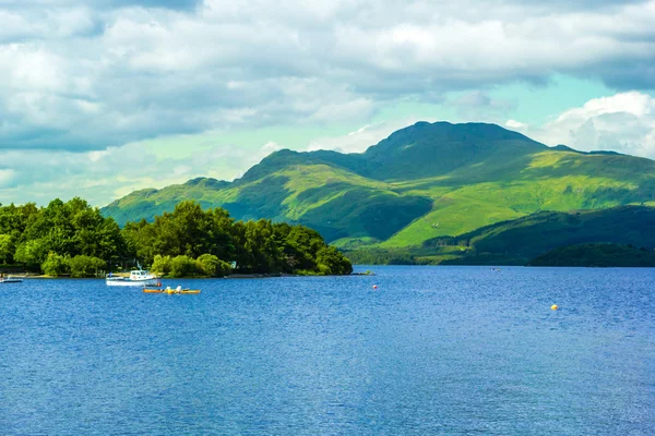 Kajak na spokojny niebieski jezioro Loch Lomond Luss w Szkocji — Zdjęcie stockowe