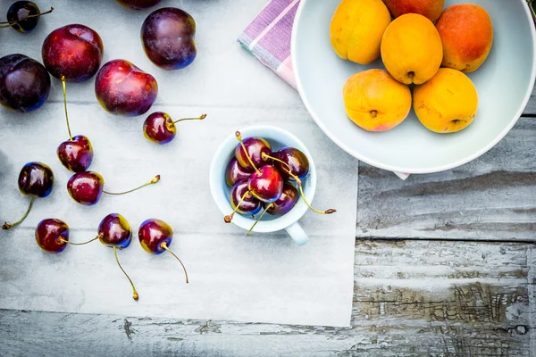 Pedra fruta do outono sobre a mesa de madeira, vista plana . — Fotografia de Stock