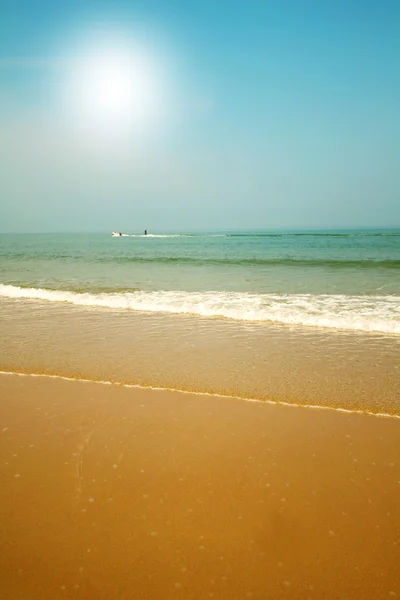 Piękna plaża z piaskiem, Błękitne fale i niebo — Zdjęcie stockowe