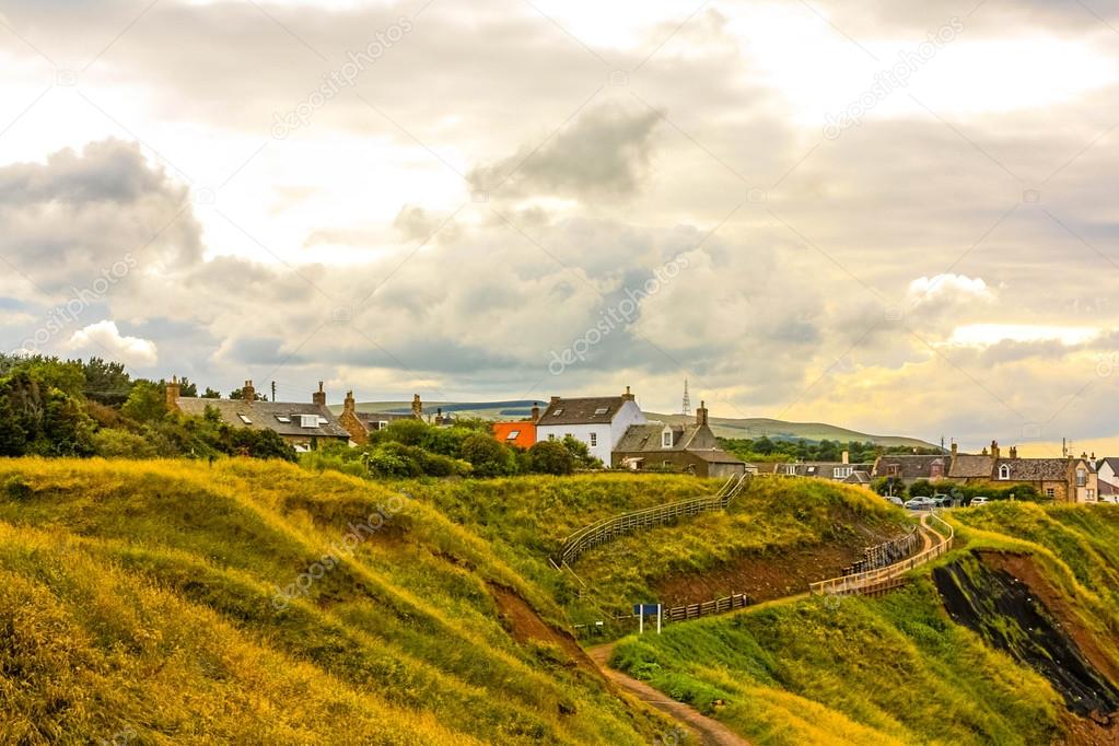 Beautiful Scottish coastline with houses on the hills