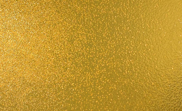 Gold wall texture background. Yellow shiny gold paint on wall serface with light reflection, vibrant golden luxury wallpaper shee