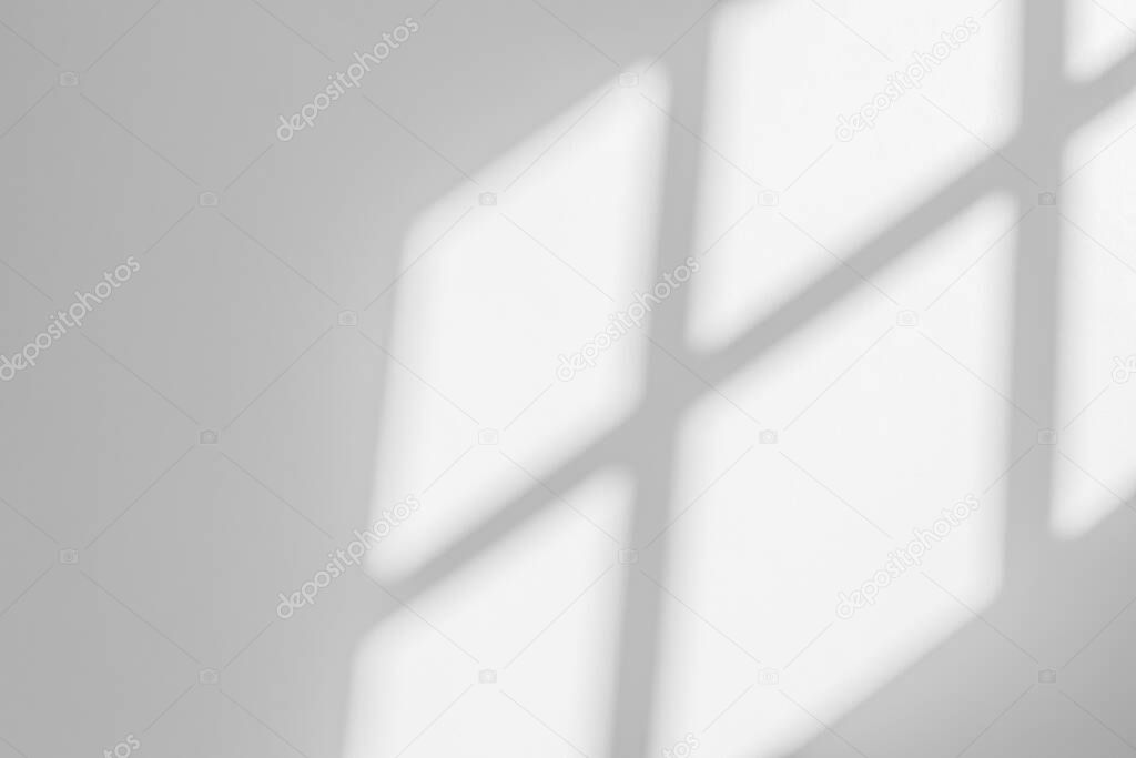 Abstract light reflection and grey shadow from window on white wall background , dark gray and sunshine diagonal geometric effect overlay for backdrop and mockup desig