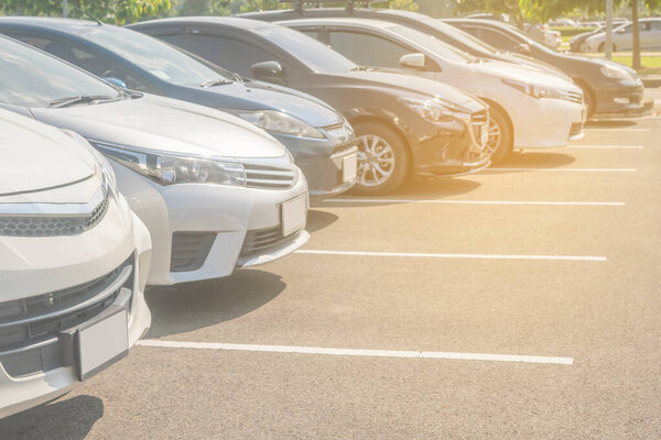 Car parking in asphalt parking lot in a row, front of  cars close up, automobile transportation dealer business concep