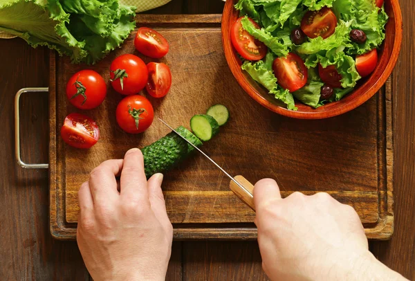 Groente salade (sla, tomaten, komkommers) koken op een houten plank, bovenaanzicht — Stockfoto