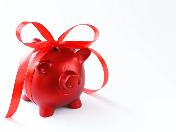 Money box red piggy bank with gift ribbon — Stock Photo, Image