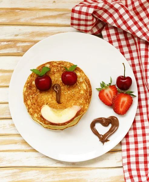 breakfast pancakes with berries (strawberry, cherry, banana), funny face