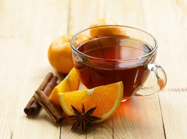 Glass cup of  tea with anise, cinnamon and citrus fruits on the table — Stock Photo, Image