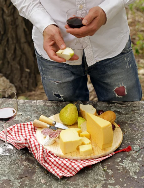 Tabla de quesos con peras y vino en una mesa en el jardín — Foto de Stock