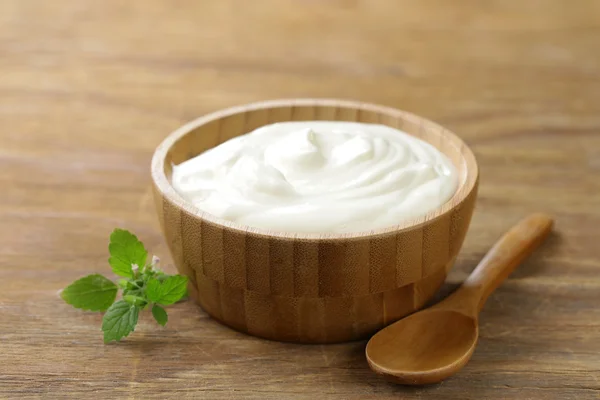 Homemade organic sour cream in a wooden bowl — Stock Photo, Image