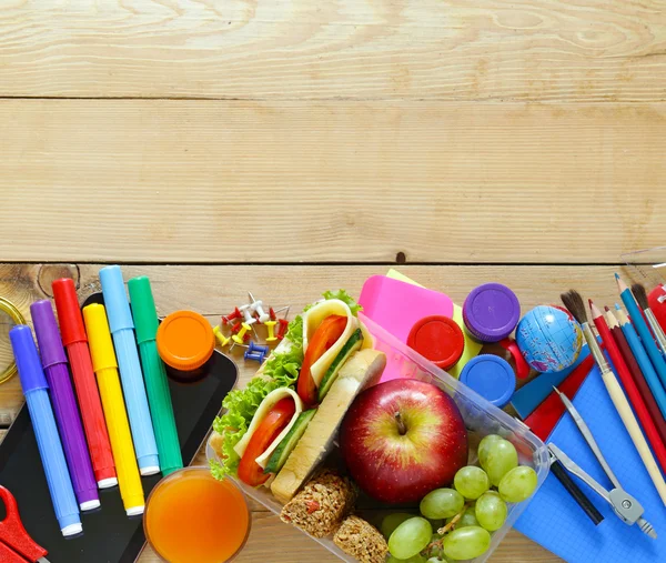 Papeterie scolaire et boîte à lunch avec pomme, raisin et sandwich — Photo