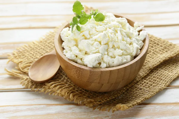 Homemade organic cottage cheese in a wooden bowl — Stock Photo, Image