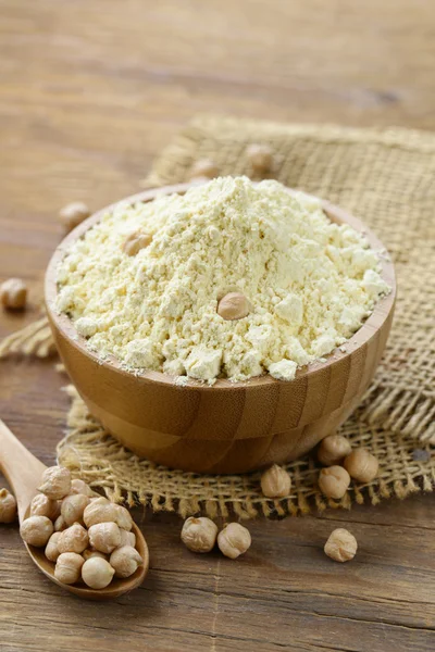 Chickpea flour in a wooden bowl on the table — Stock Photo, Image