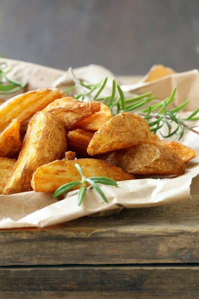 Slices of fried potatoes with rosemary and spices — Stock Photo, Image