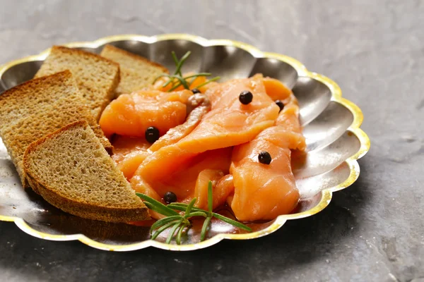 Salty salmon red fish with black pepper and rosemary — Stock Photo, Image