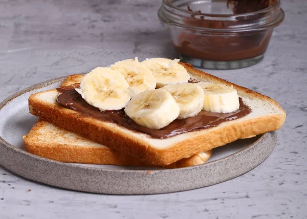 stock image breakfast sandwiches with banana and chocolate on the table