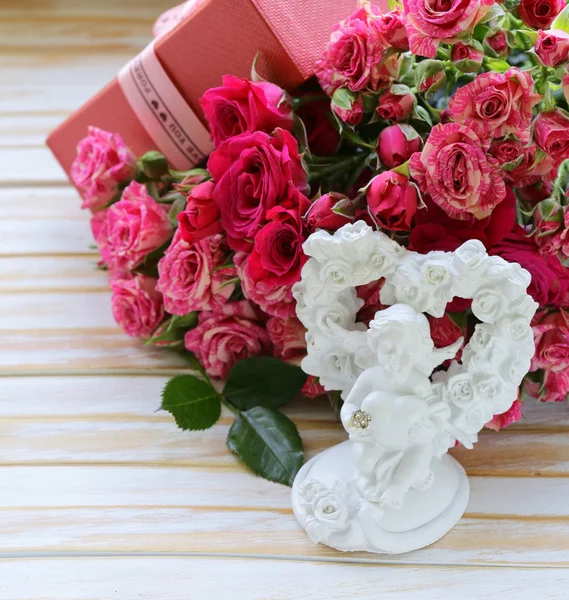 Ramo de rosas con caja de regalo sobre fondo de madera —  Fotos de Stock