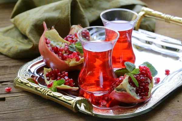 Pomegranate fruit tea in traditional glass cups — Stock Photo, Image