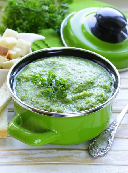 Vegetable broccoli cream soup with white croutons and parsley