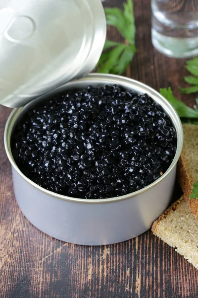 Caviar with rye bread and two shots vodka on a wooden table — Stock Photo, Image