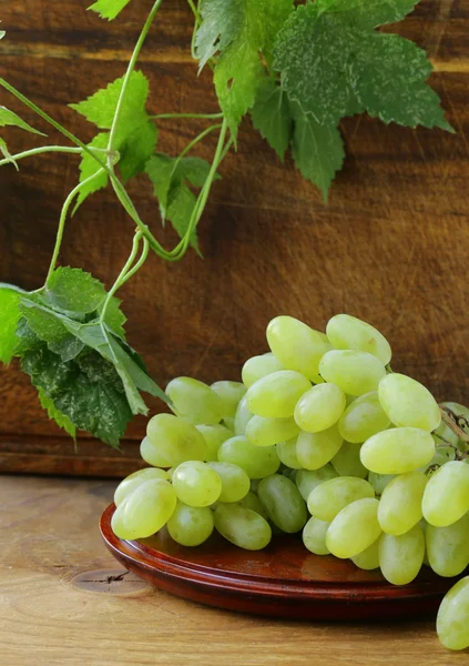 Świeży zielony winogron na drewnianym stołem — Zdjęcie stockowe