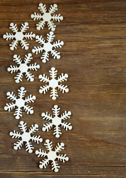 Decoraciones de fondo de Navidad y copos de nieve de madera — Foto de Stock