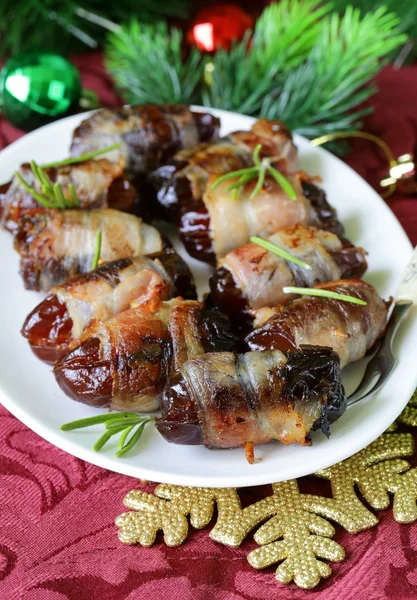 Appetizer delicacy dates wrapped in bacon and fried — Stock Photo, Image