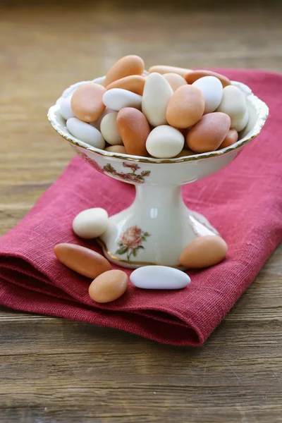 Candy dragee almond glaze in a cup on the table — Stock Photo, Image