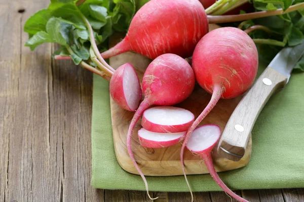 Fresh organic radishes on a wooden board — Stock Photo, Image