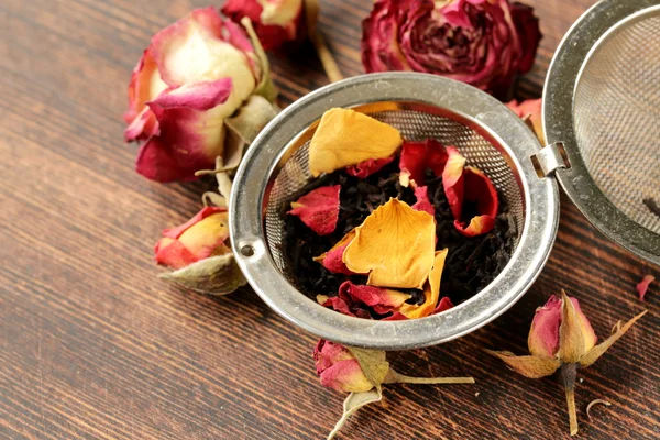 Natural organic tea from dry roses on a wooden background — Stock Photo, Image