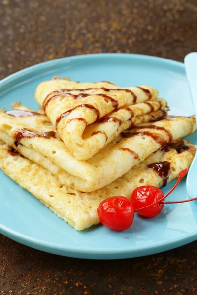 Thin pancakes with chocolate sauce on a plate — Stock Photo, Image