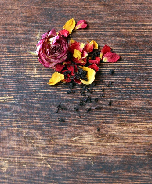 Natural organic tea from dry roses on a wooden background — Stock Photo, Image