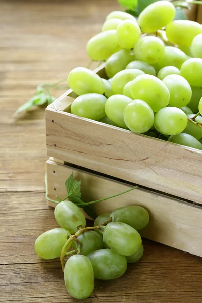 Uvas verdes orgánicas frescas en una mesa de madera — Foto de Stock