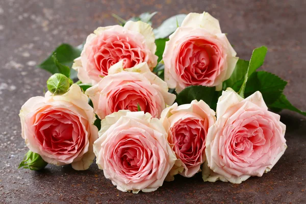 Boeket van roze rozen op een houten tafel — Stockfoto