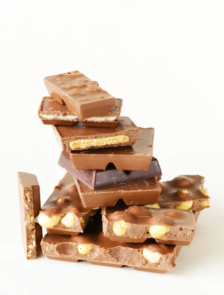 Stack of bars pieces of chocolate with different flavors — Stock Photo, Image