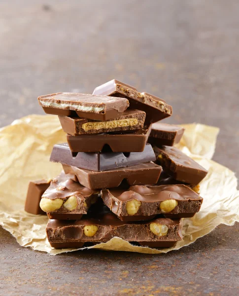 Stack of bars pieces of chocolate with different flavors — Stock Photo, Image