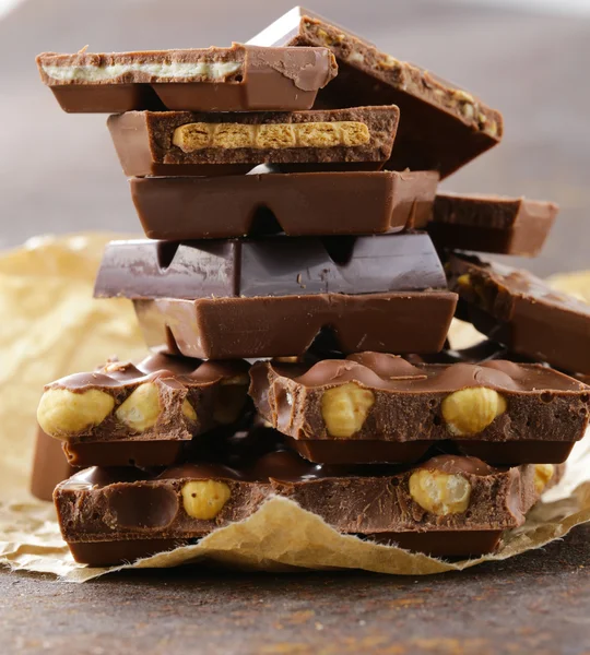 Stack of bars pieces of chocolate with different flavors — Stock Photo, Image