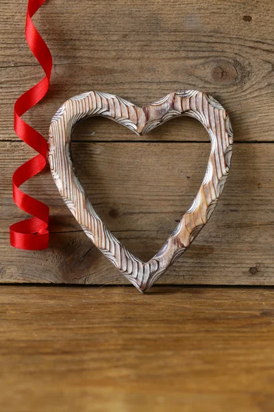 Wooden heart symbol of love on the old background — Stock Photo, Image