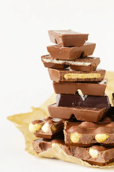 Stack of bars pieces of chocolate with different flavors — Stock Photo, Image