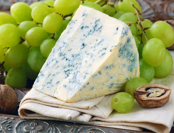 Piece of blue cheese with fruits and herbs — Stock Photo, Image