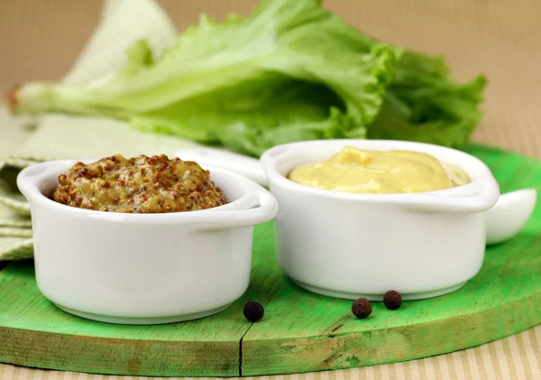 Traditional sauce dijon mustard on a wooden table — Stock Photo, Image