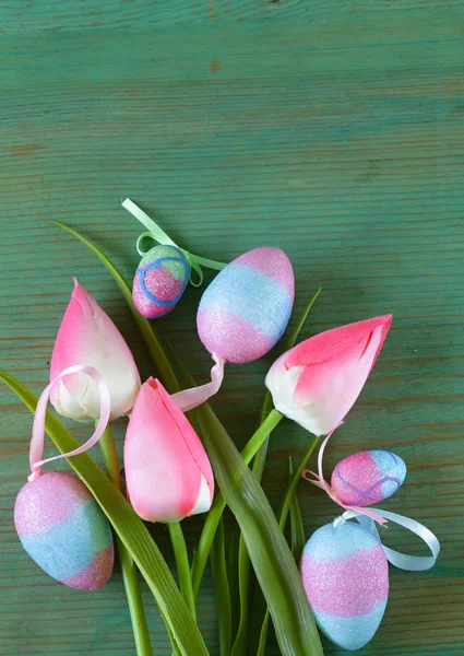 Färgglada dekorativa påskägg och gren med vårblommor på den gamla trä bakgrunden — Stockfoto