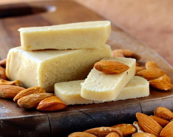 Marzipan-Mandelriegel-Brot, wünscht frische Mandeln auf einem Holzbrett — Stockfoto