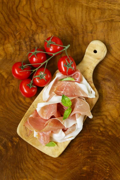 Parma ham (jamon) with fragrant herbs traditional Italian meat appetizer — Stock Photo, Image