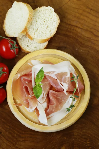 Parma ham (jamon) with fragrant herbs traditional Italian meat appetizer — Stock Photo, Image