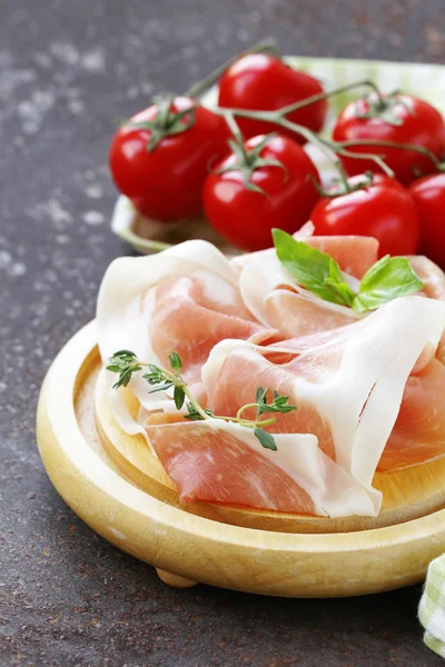 Parma ham (jamon) with fragrant herbs traditional Italian meat appetizer — Stock Photo, Image