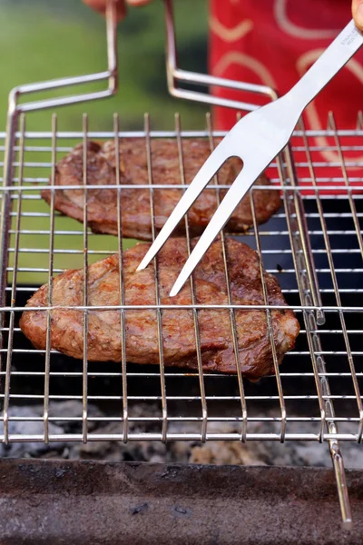 Cooking on the barbecue grill  beefsteak and skewers — Stock Photo, Image