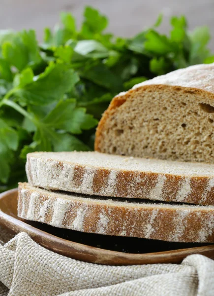 Homemade loaf of rye bread on a wooden plate — Stock Photo, Image