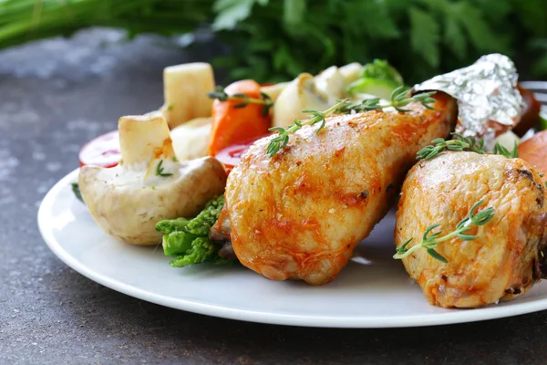 Fried chicken legs with herbs and spices, vegetables for garnish — Stock Photo, Image