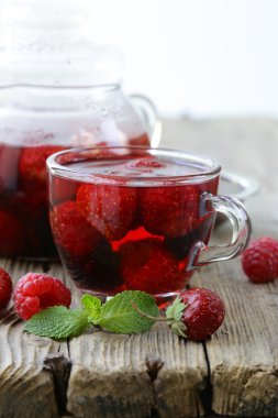 ahşap bir masa üzerinde kırmızı çay meyve berry